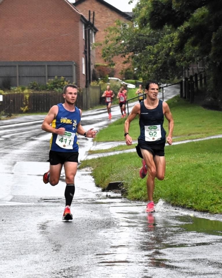Two men running in a race, illustrating exercise and immune system support during winter