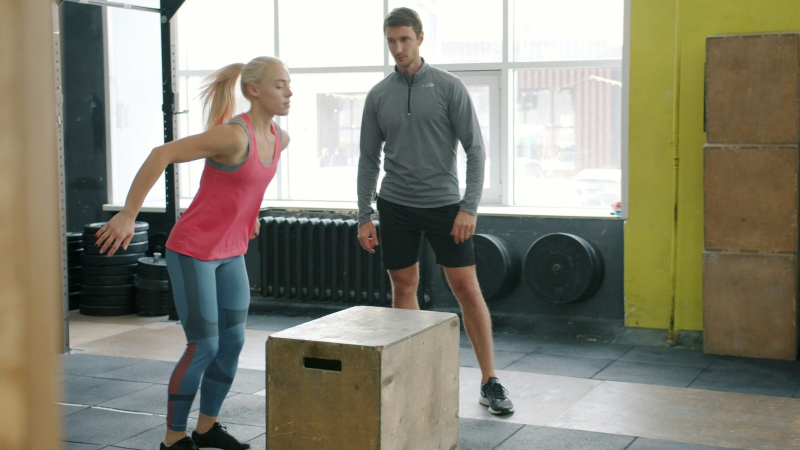 Personal trainer guiding a client through a HIIT workout for fat loss in Birmingham